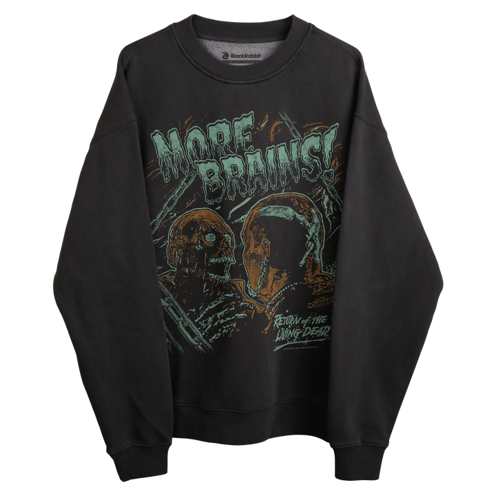Black long-sleeved sweatshirt with ’more brains’ graphic and zombie design, featuring black scale brand.