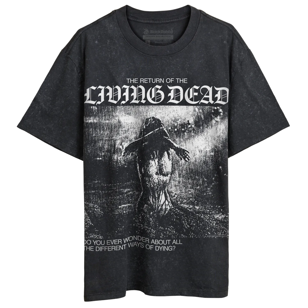 A black stone-wash graphic t-shirt featuring the text 'THE RETURN OF THE LIVING DEAD' in a gothic font above a dark, horror-themed illustration of a figure in rain, with additional text at the bottom.