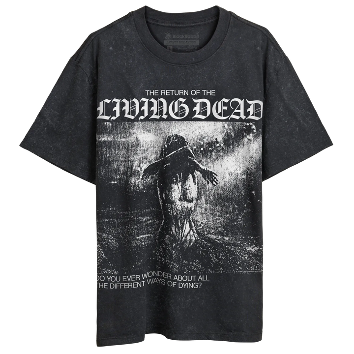 A black stone-wash graphic t-shirt featuring the text 'THE RETURN OF THE LIVING DEAD' in a gothic font above a dark, horror-themed illustration of a figure in rain, with additional text at the bottom.
