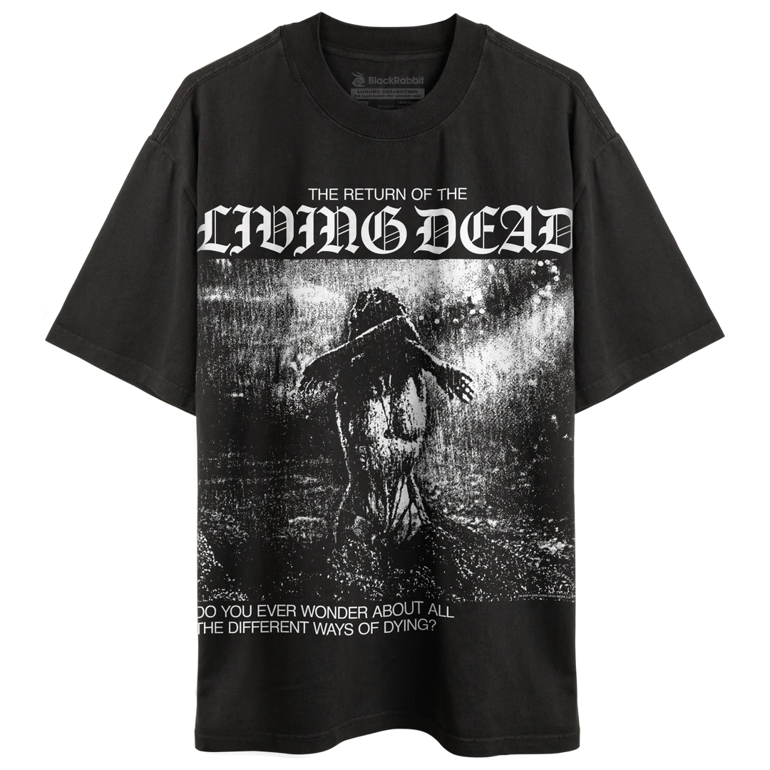 A black short-sleeve graphic t-shirt featuring the text 'THE RETURN OF THE LIVING DEAD' in a white gothic font above a dark, horror-themed illustration of a figure in a rainstorm. Below the graphic, the text reads 'DO YOU EVER WONDER ABOUT ALL THE DIFFERENT WAYS OF DYING?'.