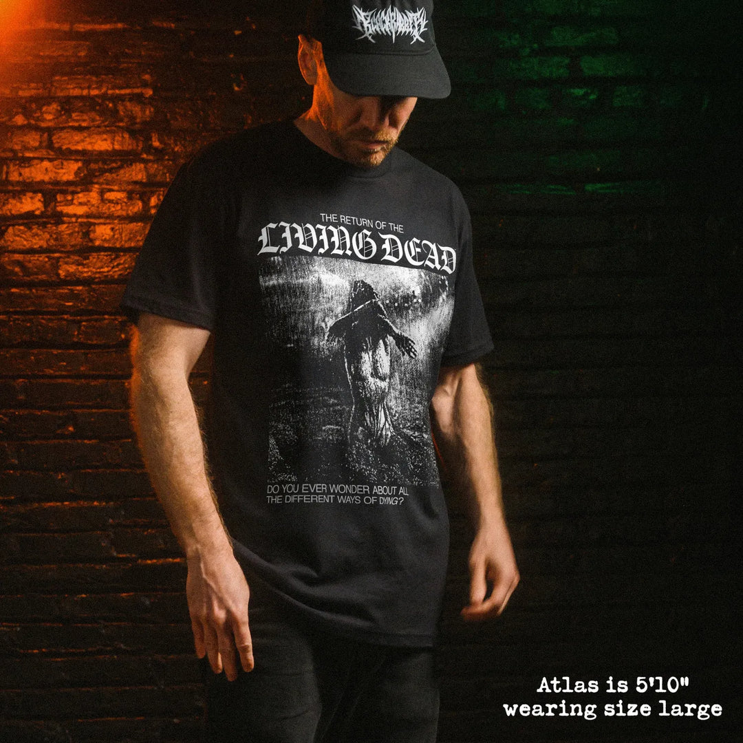 A man wearing a black graphic t-shirt with 'Return of the Living Dead' graphic.
