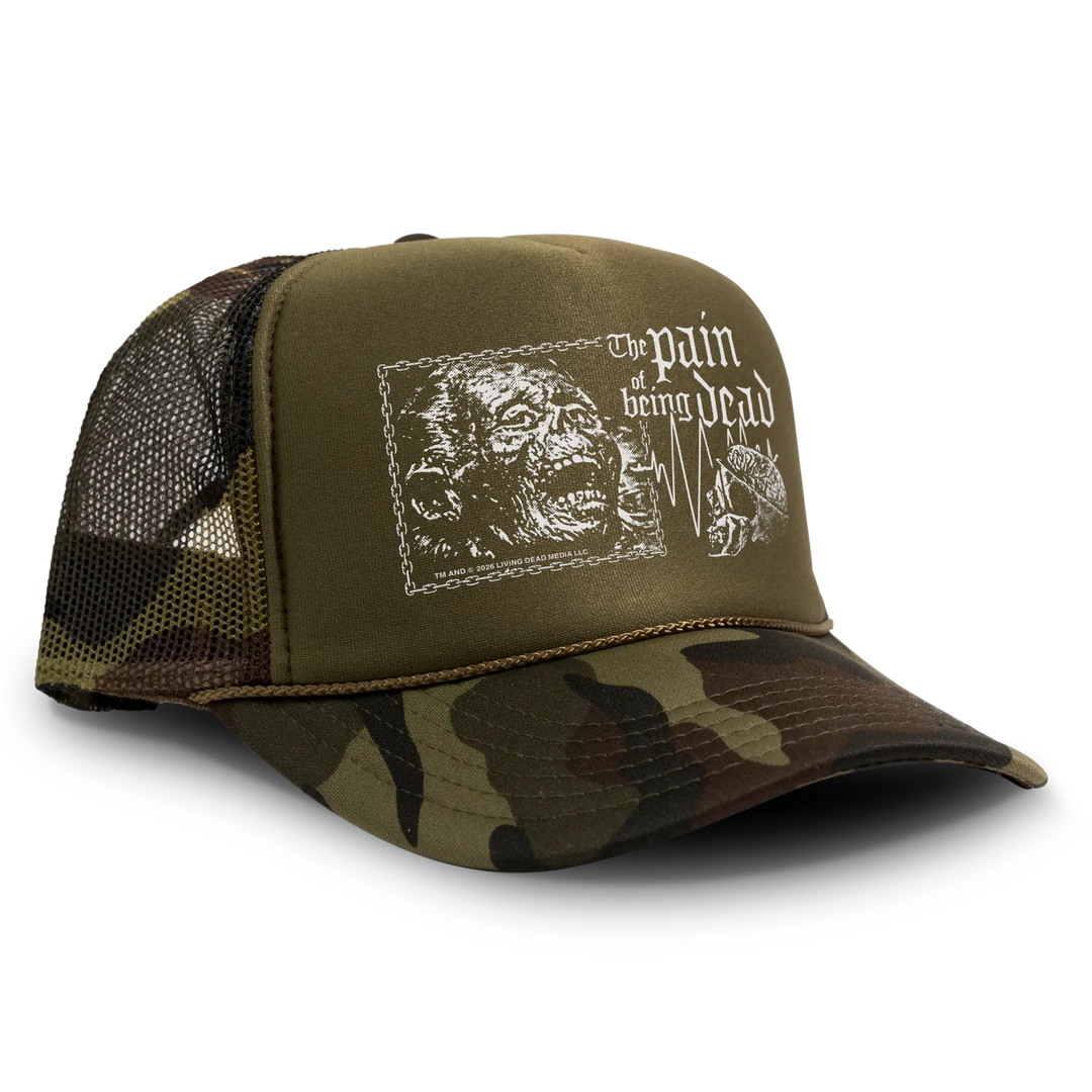 Olive green and camouflage living dead trucker hat with white zombie graphic and the pain of being dead text, officially licensed