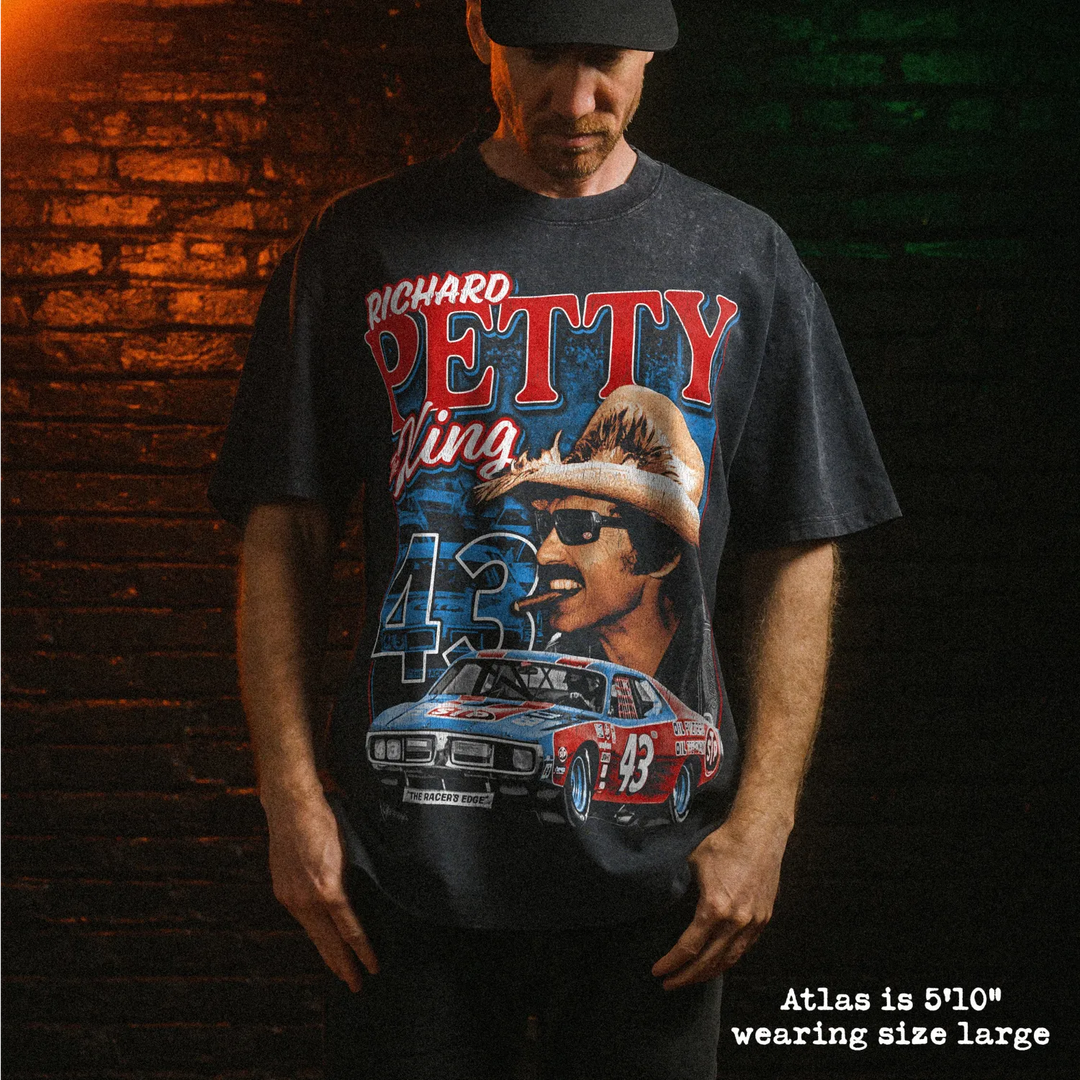 Male model wearing heavy stone washed tee with richard petty graphic. 