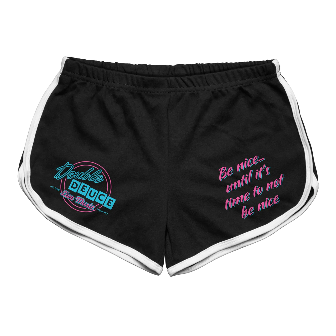 Black athletic shorts with white trim and a neon pink and teal ’double deuce’ logo on the left leg, along with the phrase “be nice...