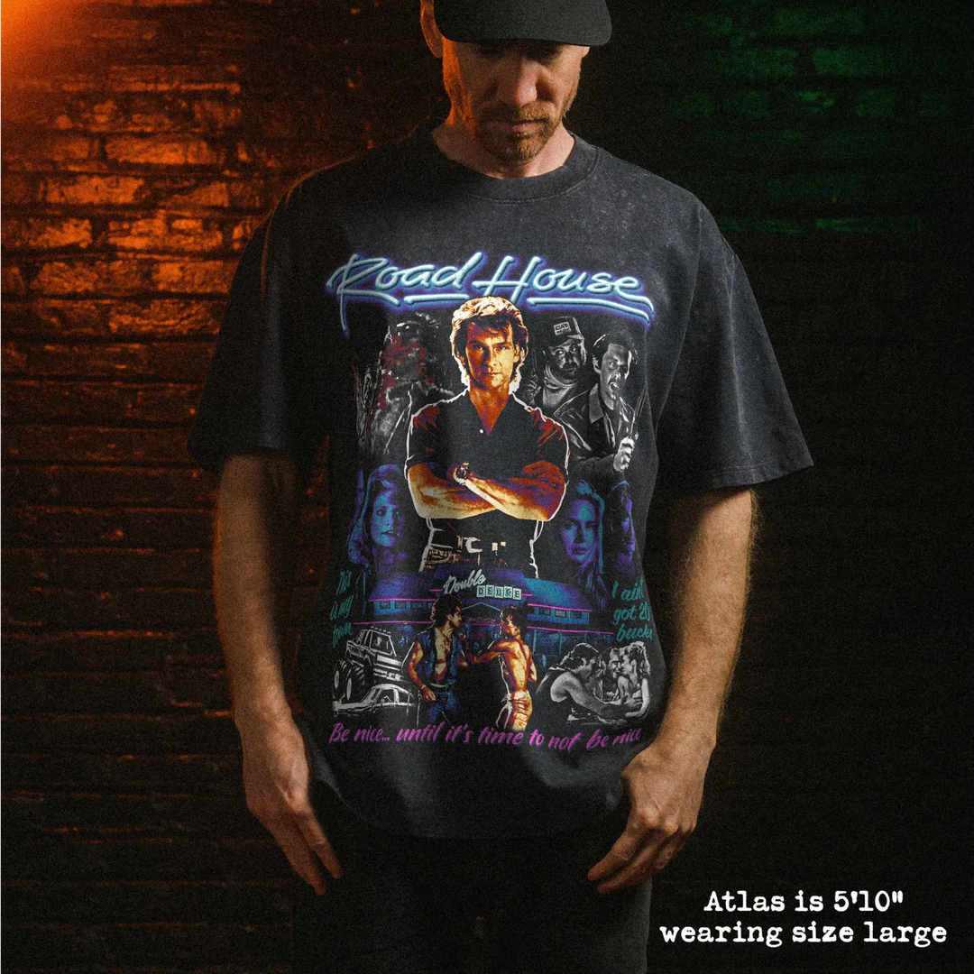 Male model wearing heavy stone washed tee with road house graphic. 