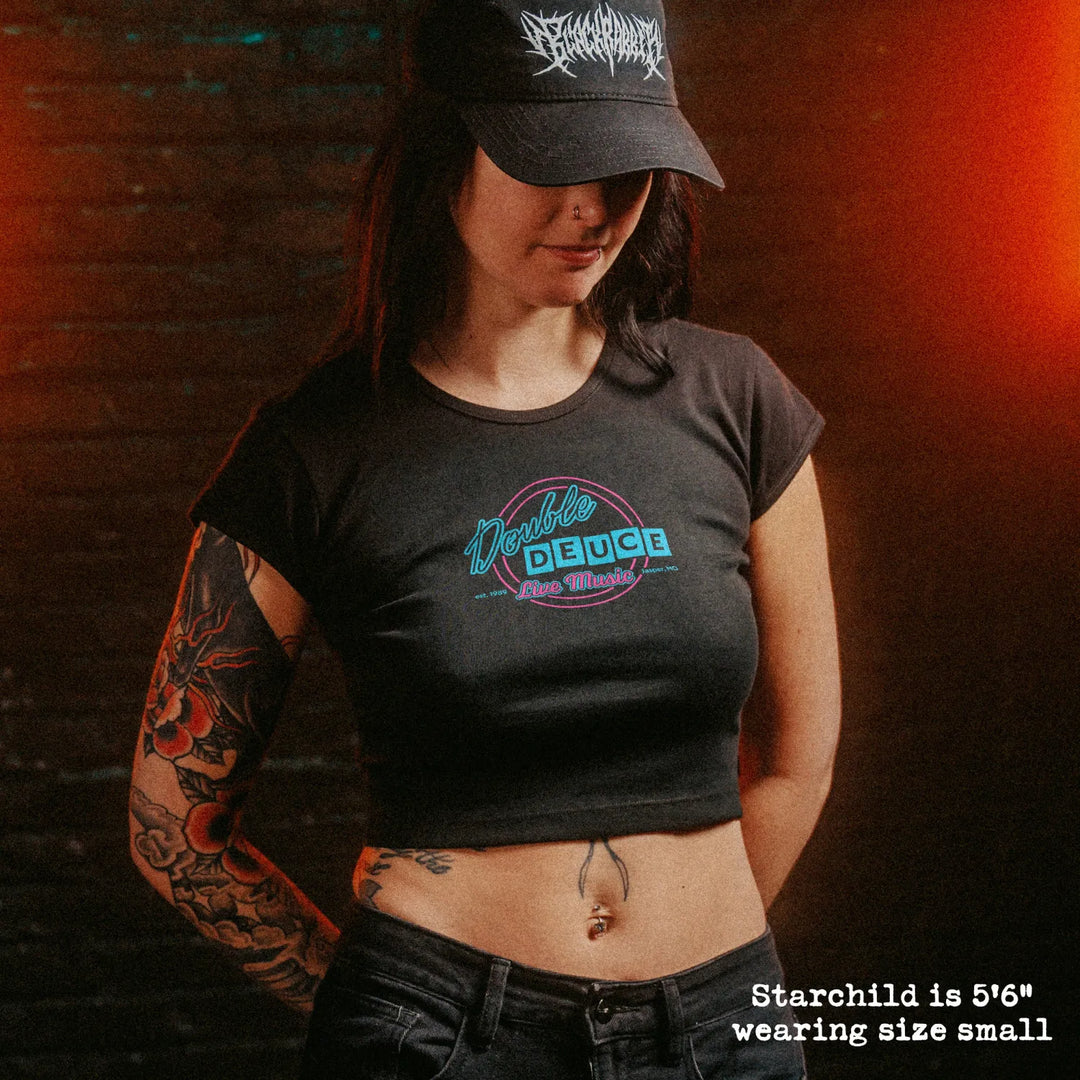 Female model wearing cropped baby tee with double deuce graphic
