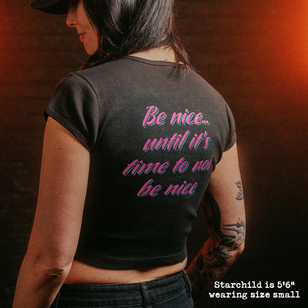 Female model wearing cropped baby tee with double deuce graphic
