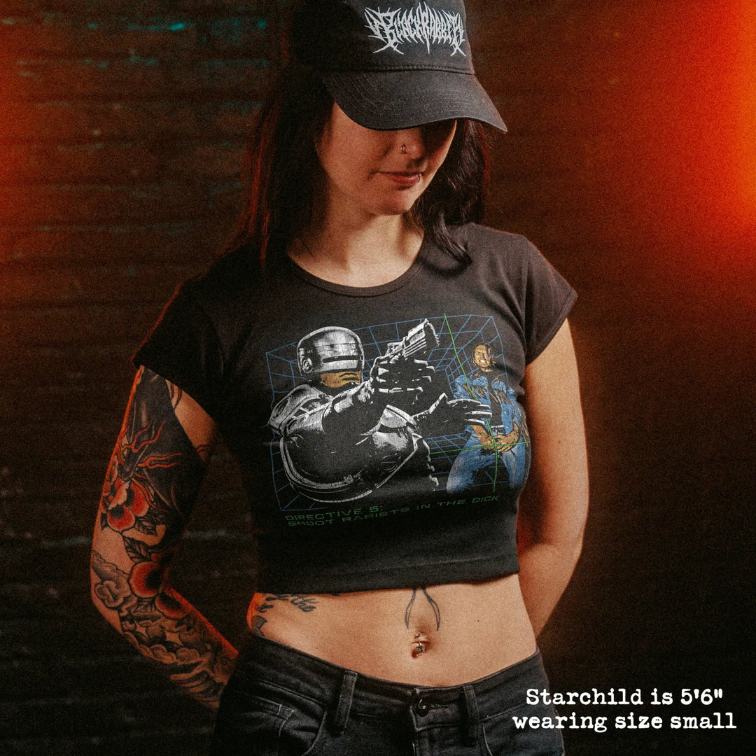 Female model wearing cropped baby tee with robocop dick shot graphic
