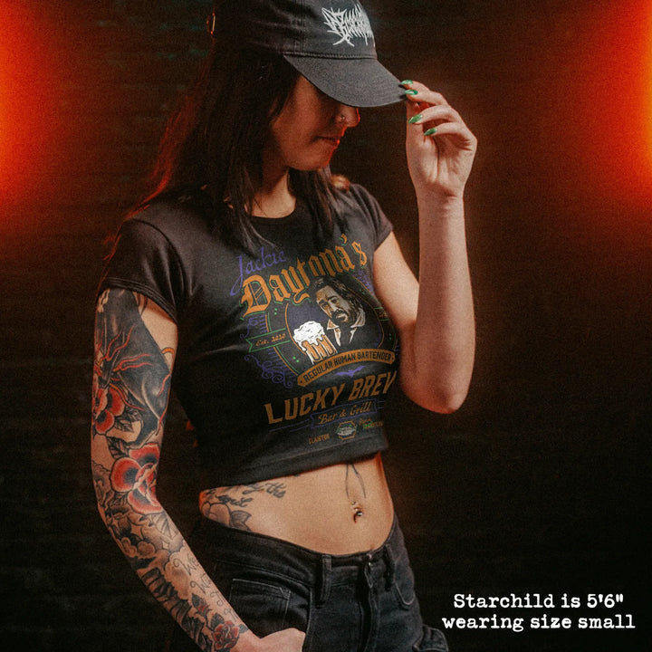 Female model wearing cropped baby tee with jackie daytona graphic
