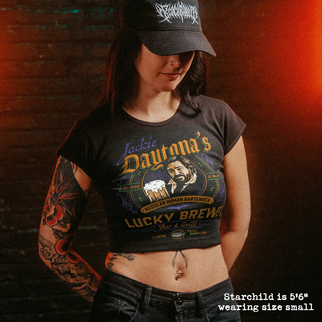 Female model wearing cropped baby tee with jackie daytona graphic
