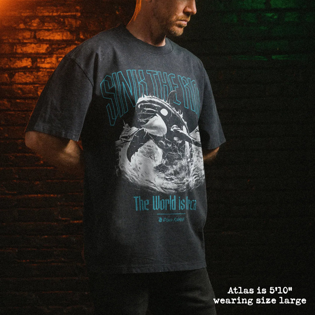 Male model wearing stone wash heavy tee with orca graphic 