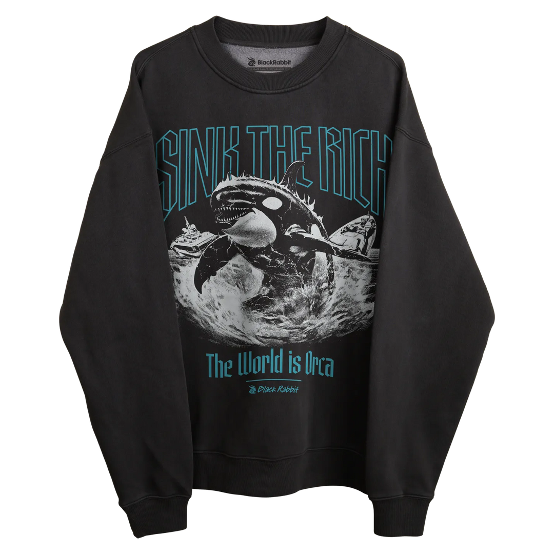 Black sweatshirt with orca whale graphic and text ’sink the rich’ in teal, featuring a crew neck.