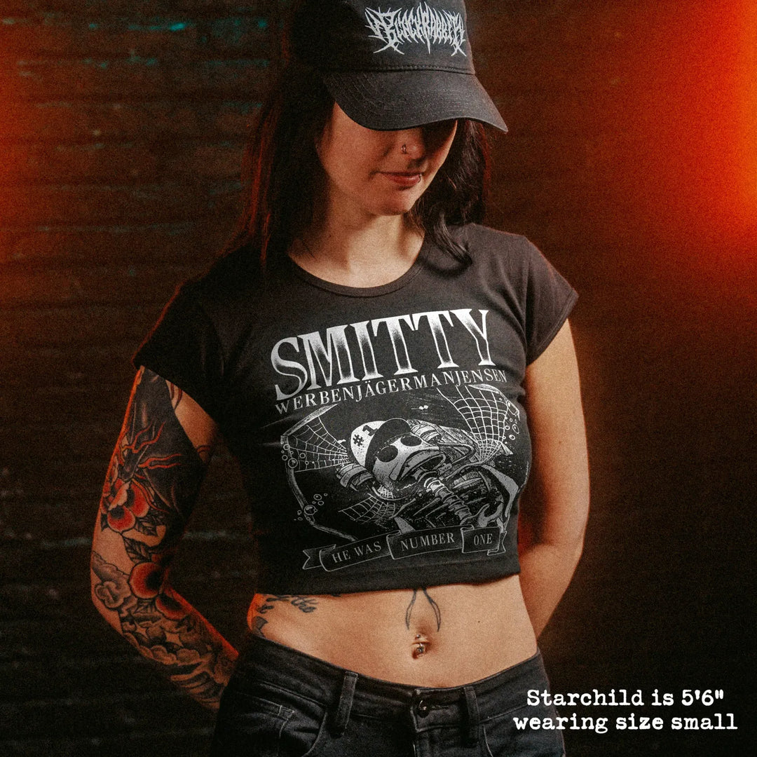 Female model wearing cropped baby tee with smitty graphic
