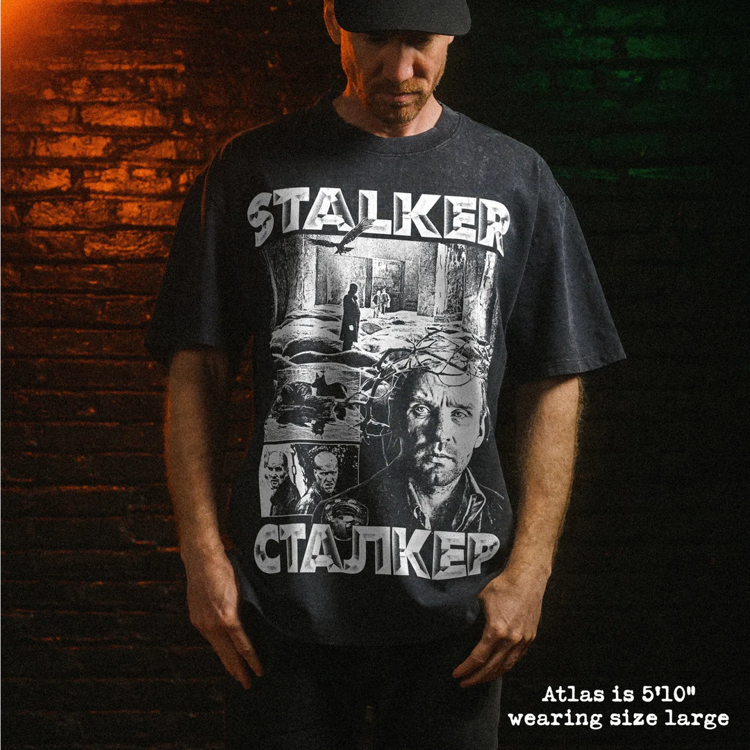 Male model wearing heavy stone washed tee with stalker graphic. 