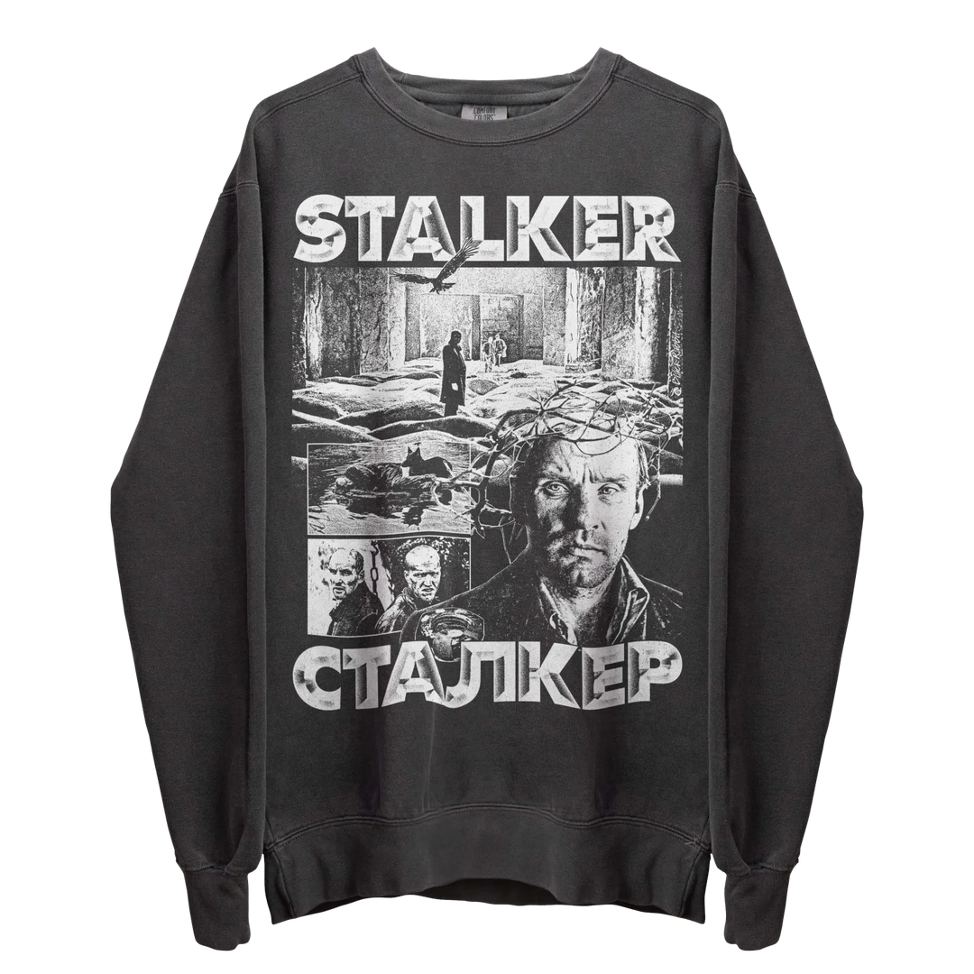 Dark grey crewneck sweatshirt with a monochrome graphic print of scenes and characters from the film ’Stalker.’