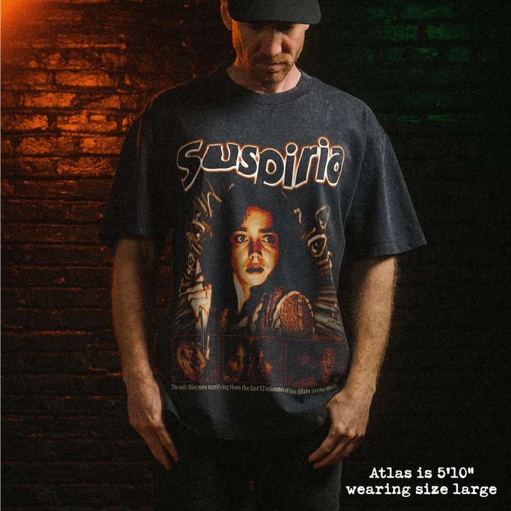 Male model wearing heavy stone washed tee with suspiria graphic. 