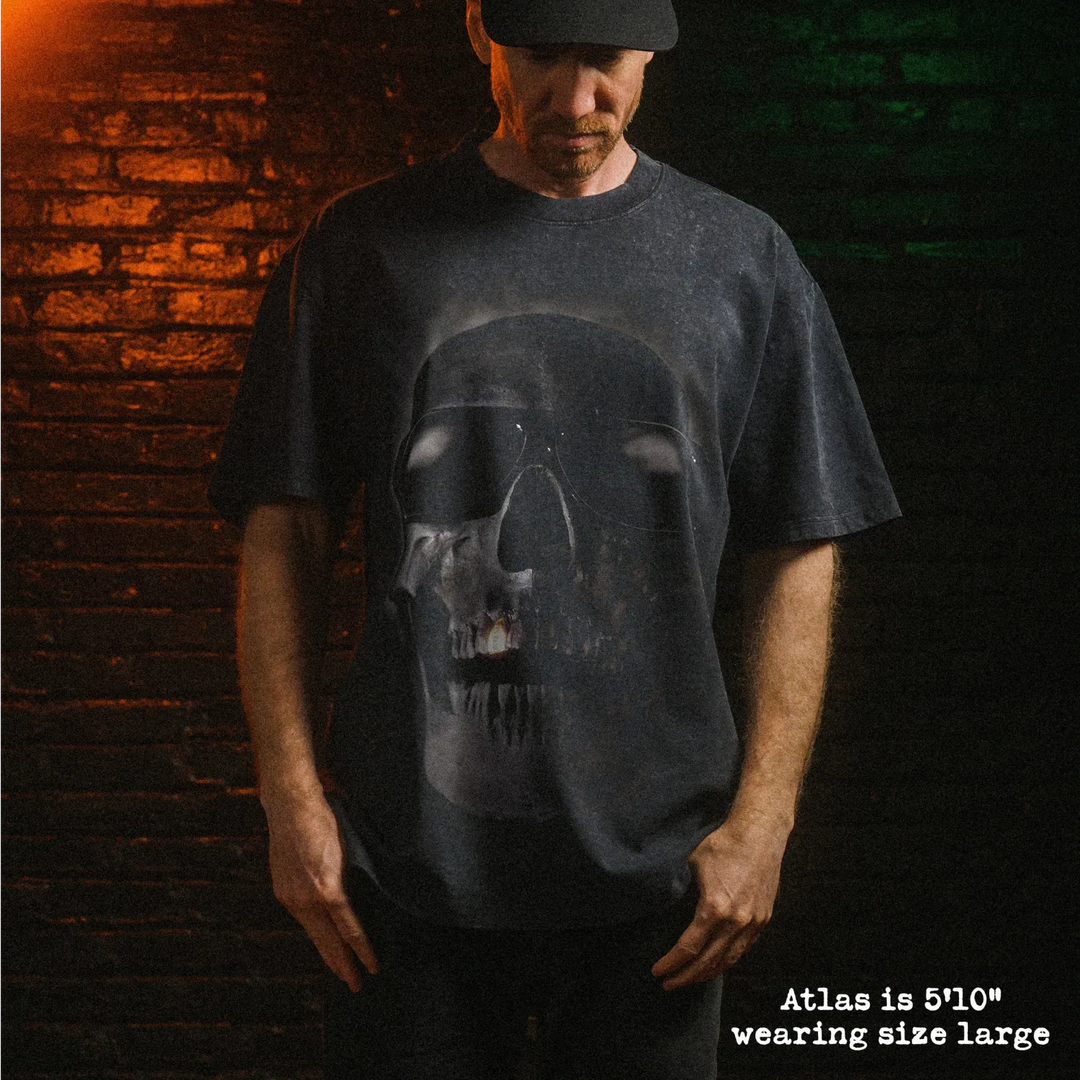Male model wearing heavy stone washed tee with tales from the hood graphic. 