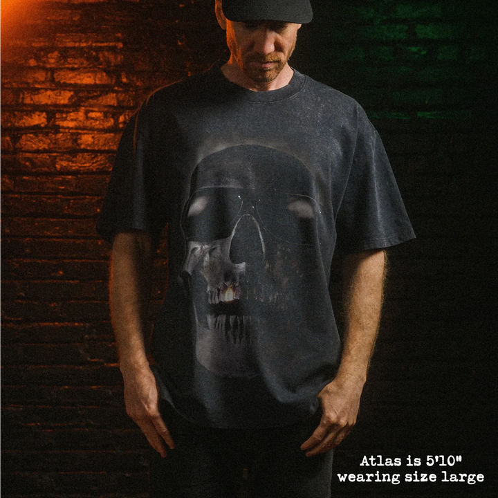 Male model wearing heavy stone washed tee with tales from the hood graphic. 