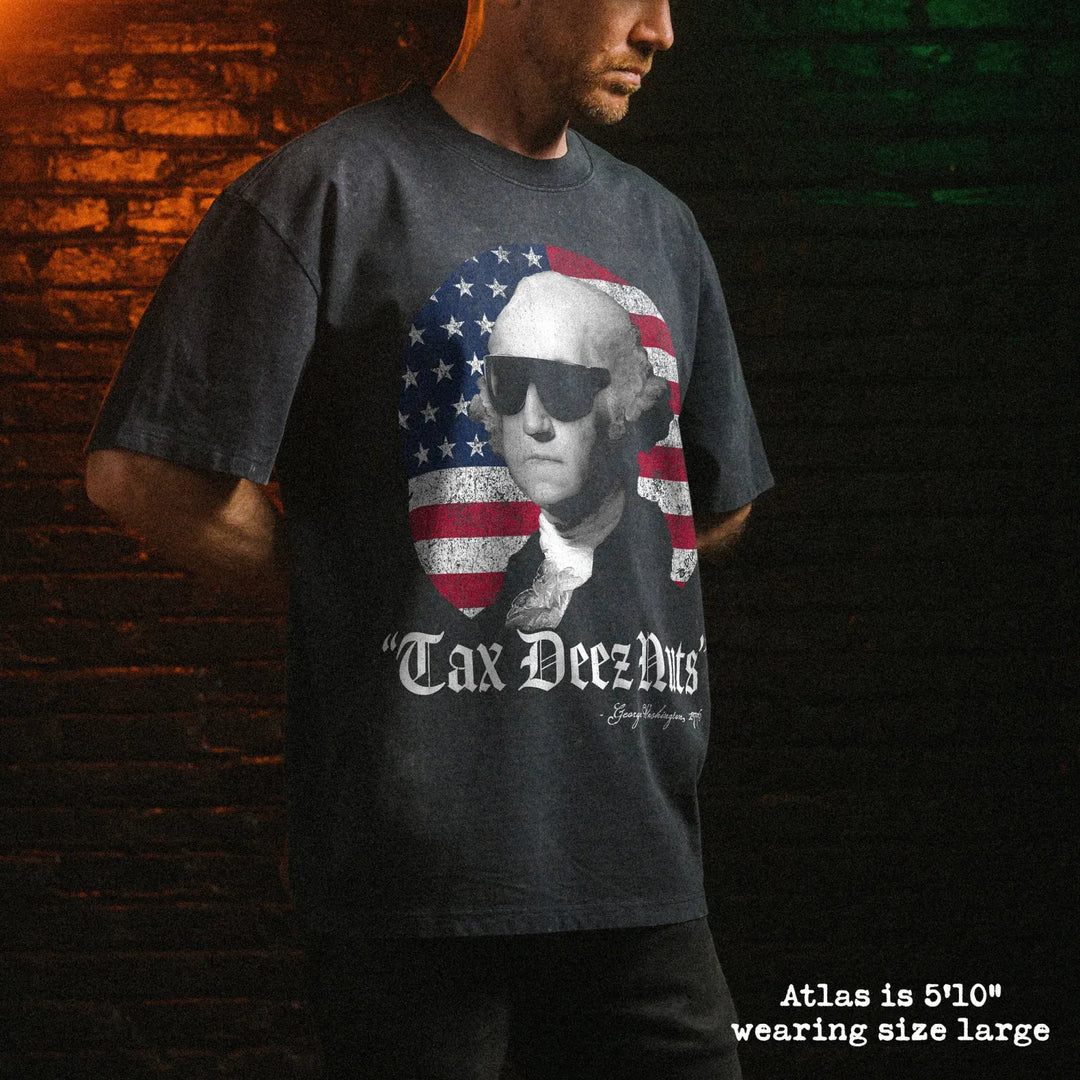Male model wearing stone wash heavy tee with tax deez nuts graphic 