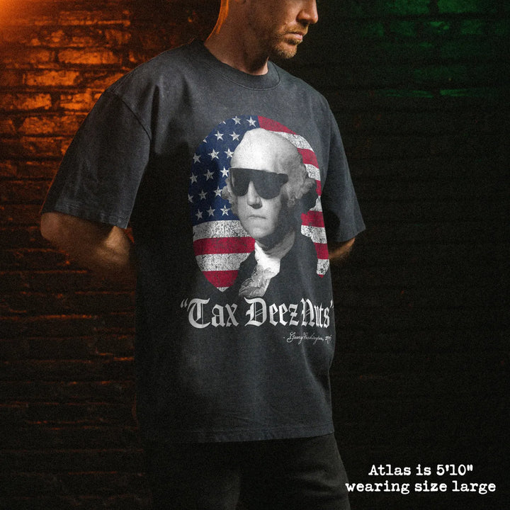 Male model wearing stone wash heavy tee with tax deez nuts graphic 