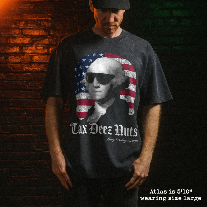 Male model wearing heavy stone washed tee with tax deez nuts graphic. 