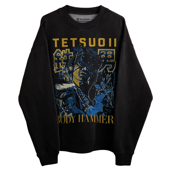 Black long-sleeved sweatshirt with tetsuo ii graphic and ’body hammer’ text in gold.