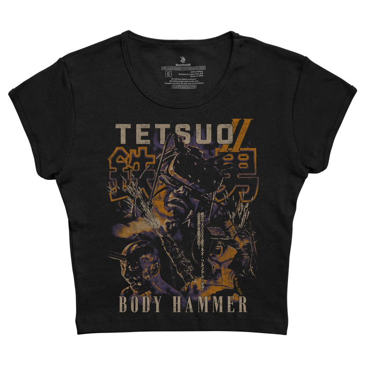 Black short-sleeved t-shirt featuring a graphic print of the anime character ’tetsuo’ with bold orange and purple lettering, designed by blackhood. 