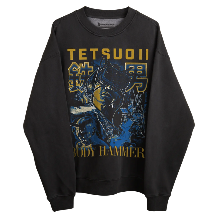 Black long-sleeved sweatshirt with graphic design of tetsuo ii and ’body hammer’ text in gold, featuring a stylized figure.