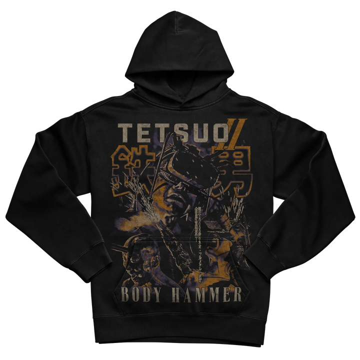Black hoodie featuring a detailed graphic of tetsuo with bold orange and yellow lettering, including the text ’tetsuo ii’ and ’body hammer.’ 