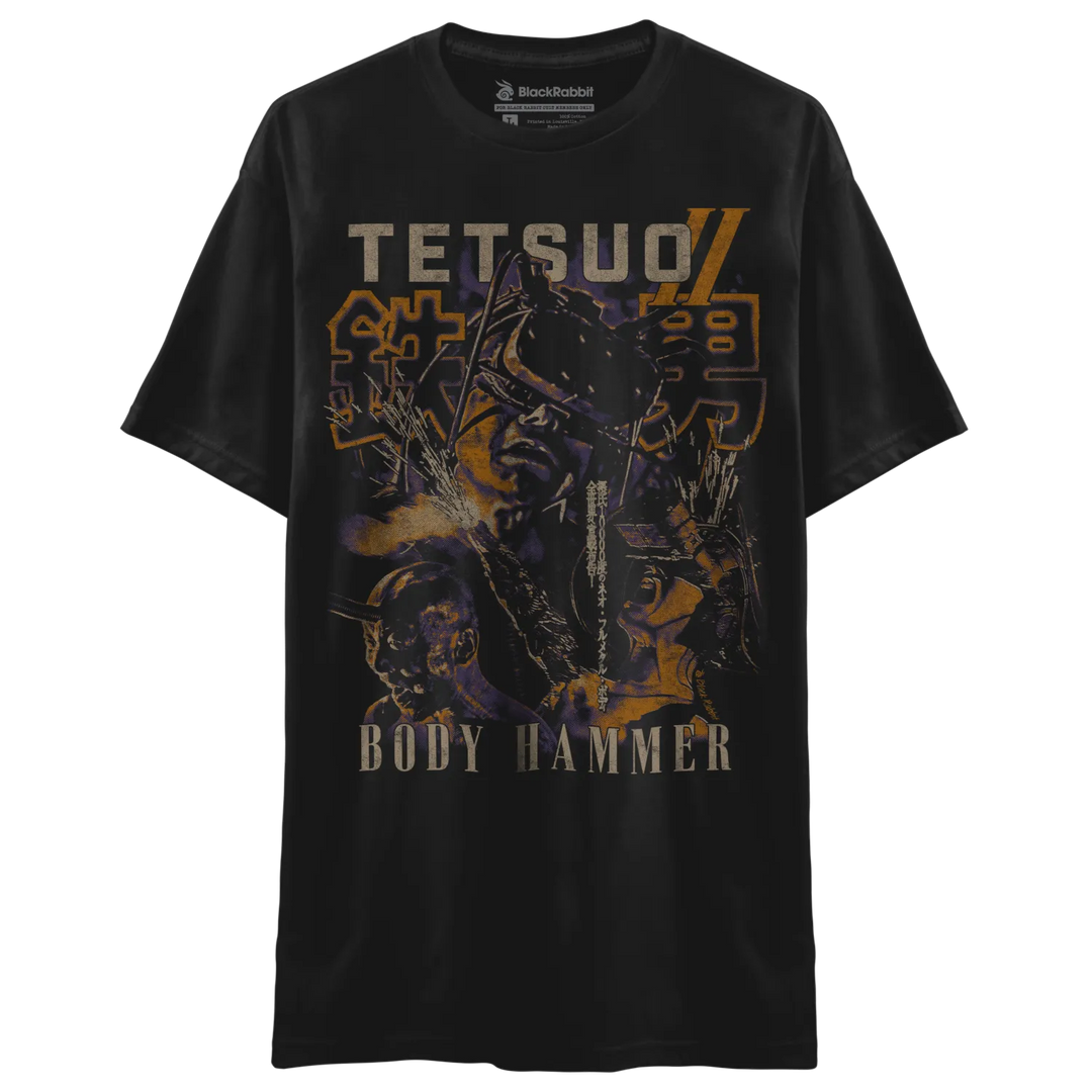 Black t-shirt featuring a graphic print with the text ’tetsuo’ and ’body hammer,’ along with stylized japanese characters, in shades of orange, yellow, purple, and black.