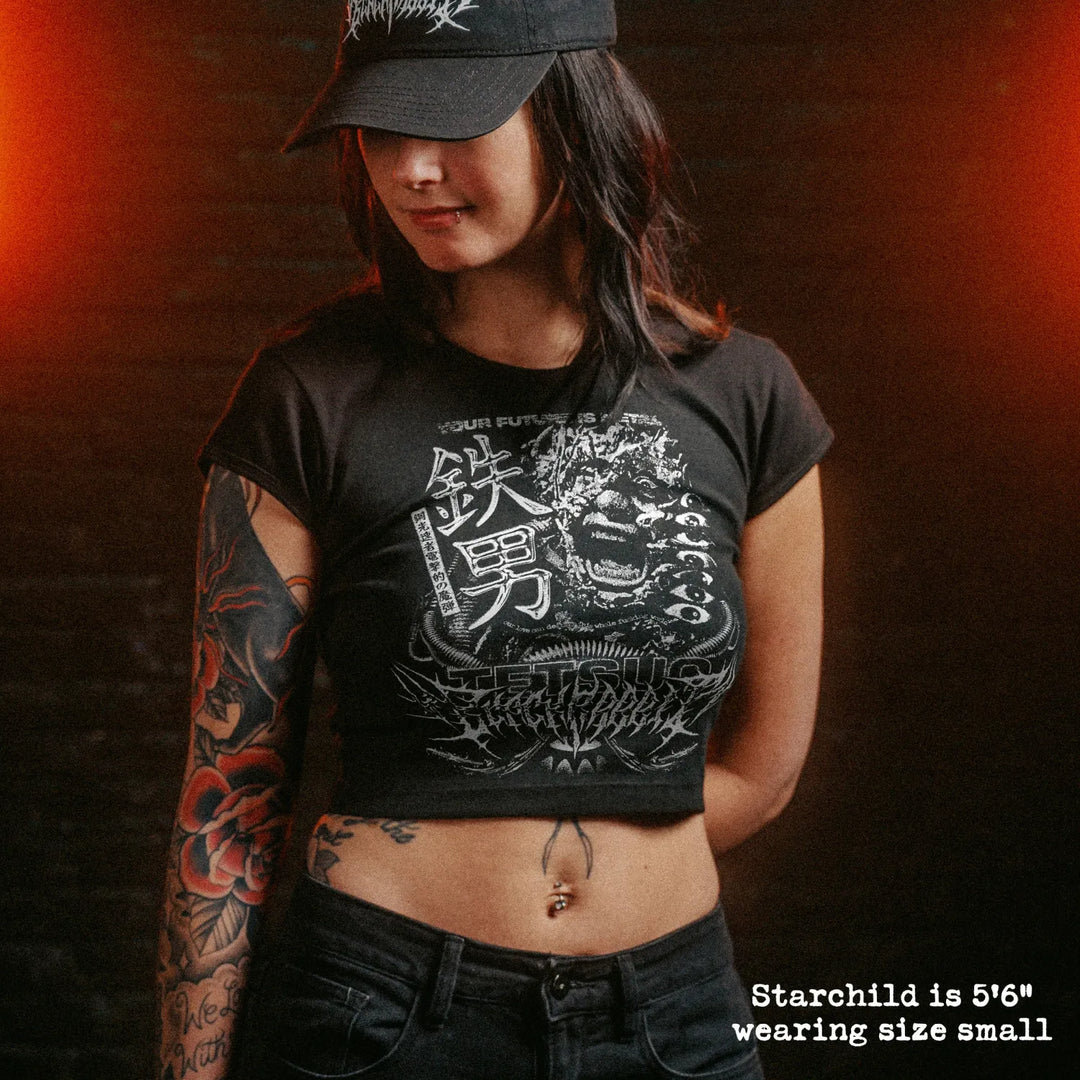 Female model wearing cropped baby tee with tetsuo graphic