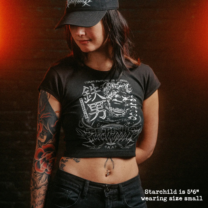 Female model wearing cropped baby tee with tetsuo graphic
