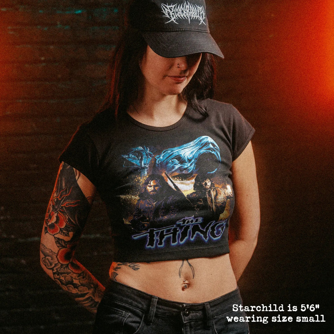 Female model wearing cropped baby tee with the thing graphic
