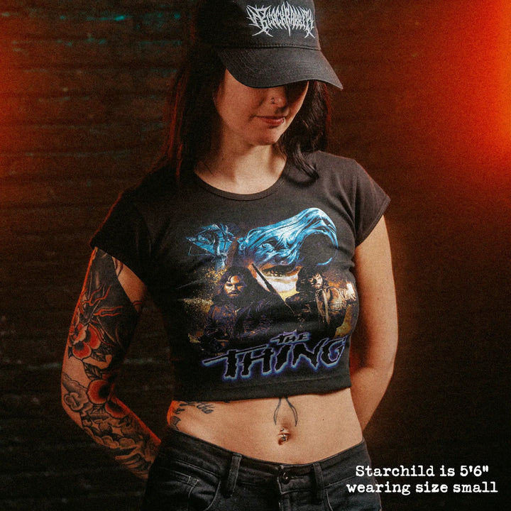 Female model wearing cropped baby tee with the thing graphic
