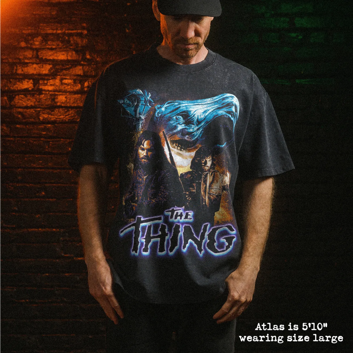 Male model wearing heavy stone washed tee with the thing graphic. 