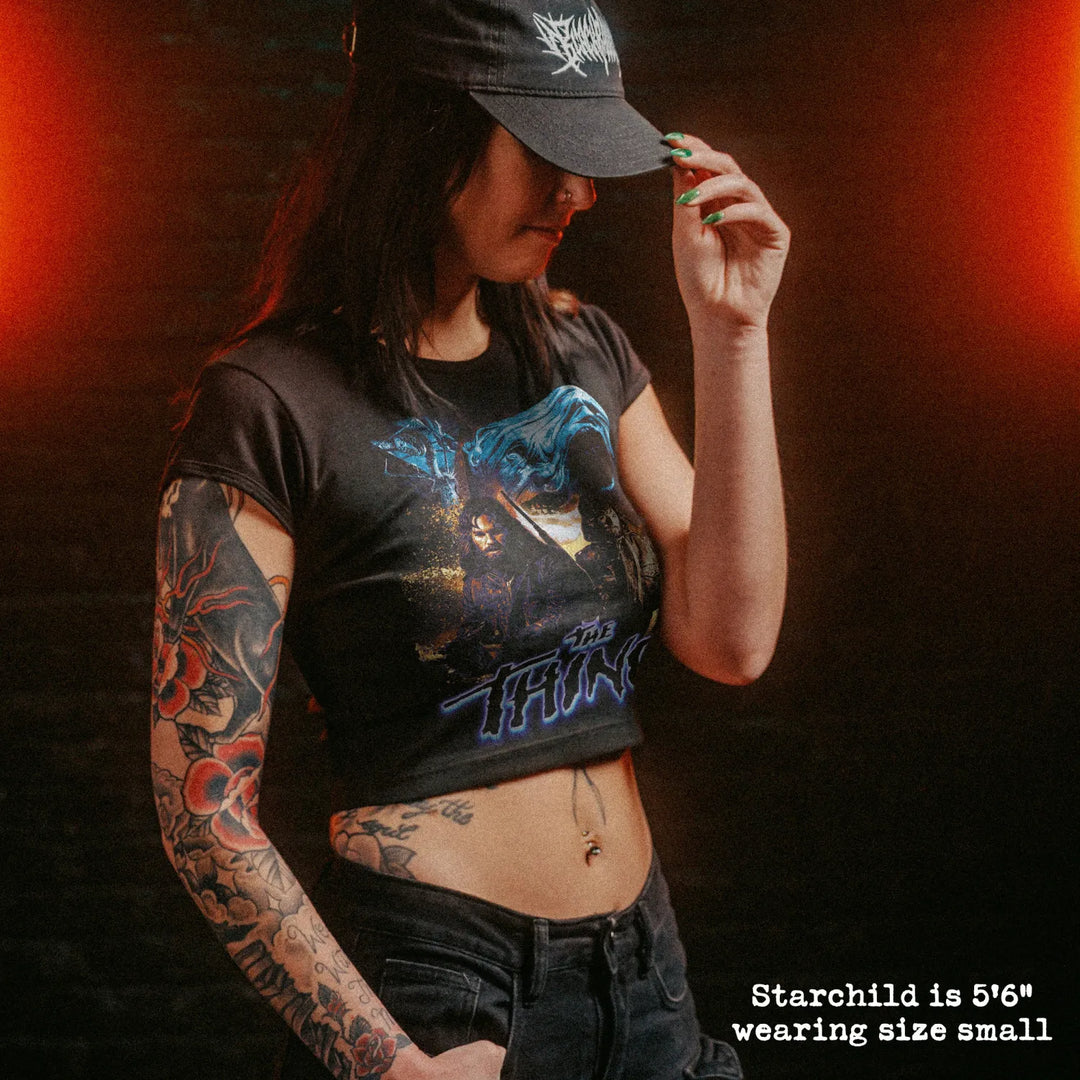 Female model wearing cropped baby tee with the thing graphic
