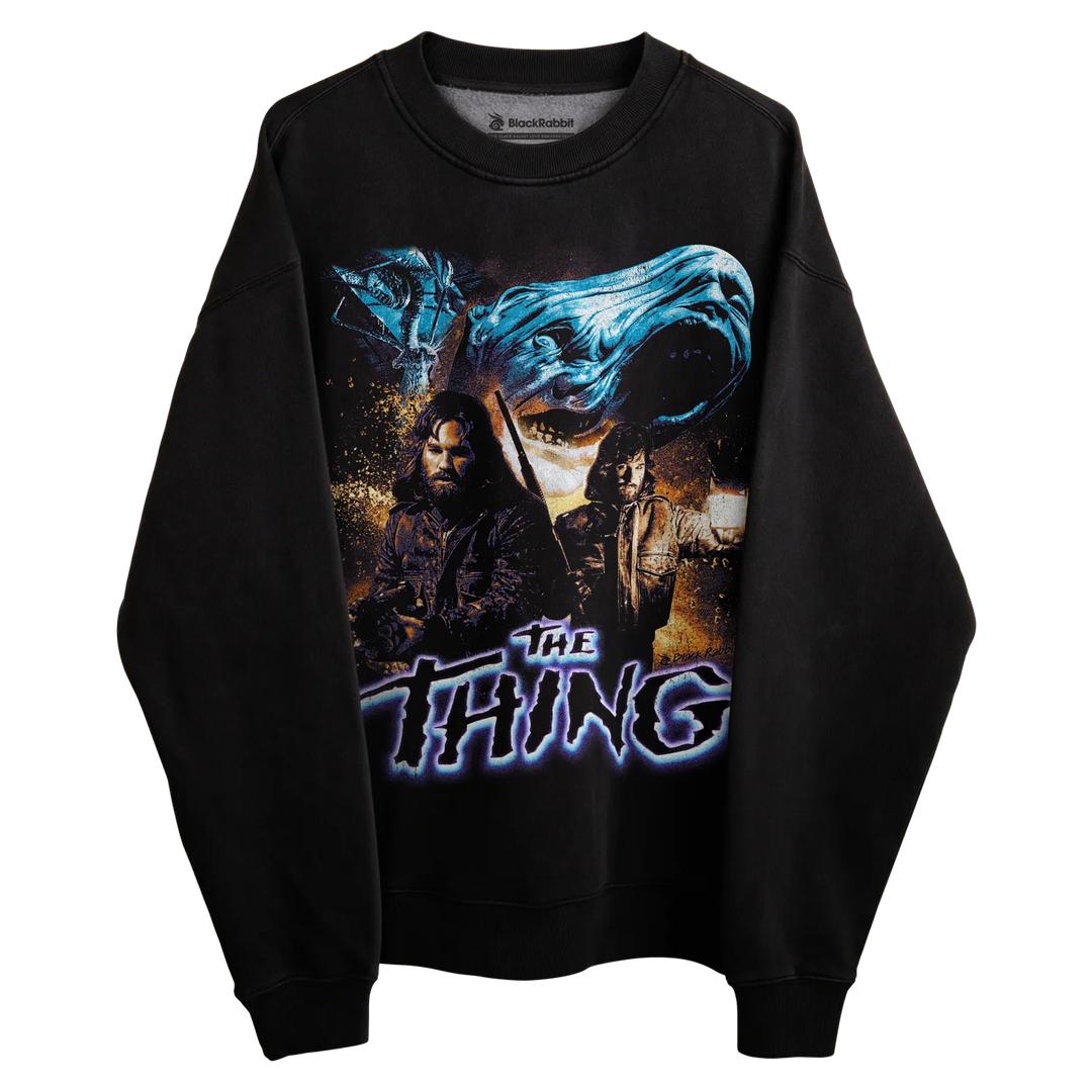 Black sweatshirt with ’the thing’ graphic design featuring a character and blue energy effect.