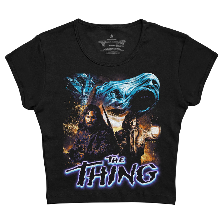 Black short-sleeved t-shirt featuring a graphic print of the movie ’the thing’ with blue and orange hues, depicting characters and a monstrous face.