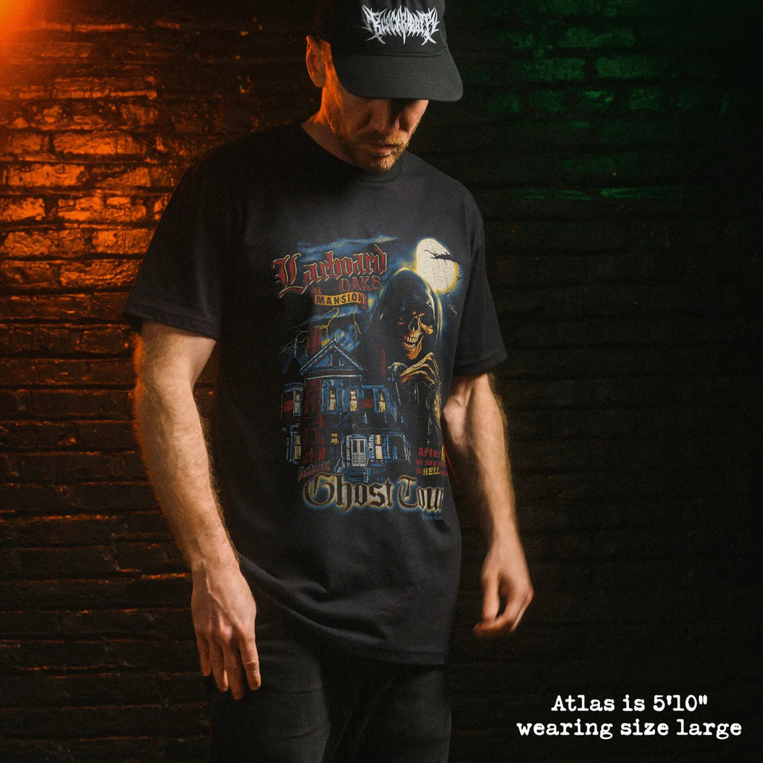 Male model wearing black premium tee with ghost tour graphic 