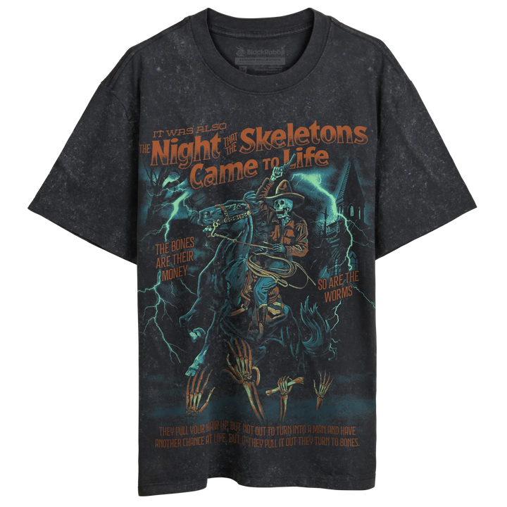 A black, distressed t-shirt with a graphic print featuring a skeleton cowboy on horseback, lightning, and a haunted house.