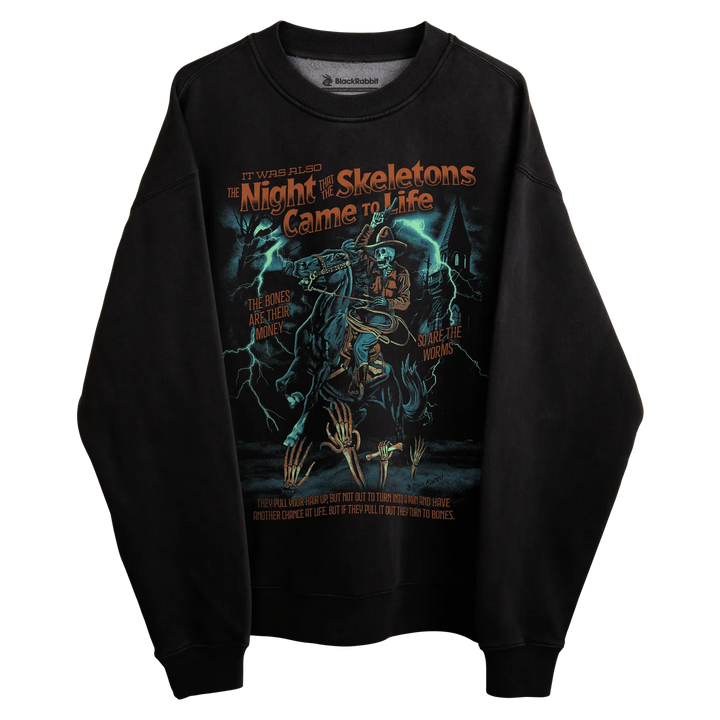 Black long-sleeved sweatshirt with ’the night the skeletons came to life’ graphic design featuring a skeleton and lightning bolts.