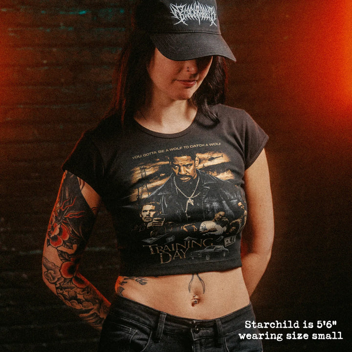 Female model wearing cropped baby tee with training day graphic
