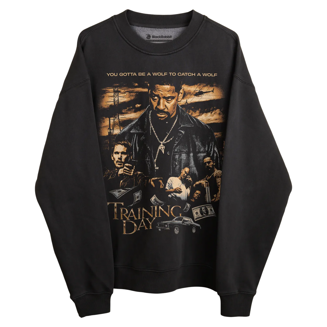 Black ’training day’ sweatshirt with graphic design featuring characters and quote.