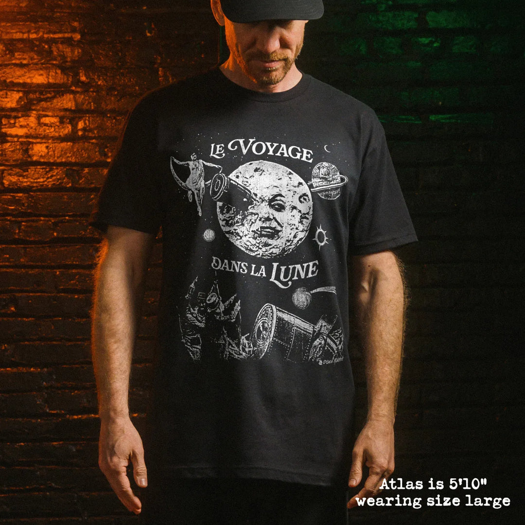 Male model wearing black premium tee with a trip to the moon graphic 