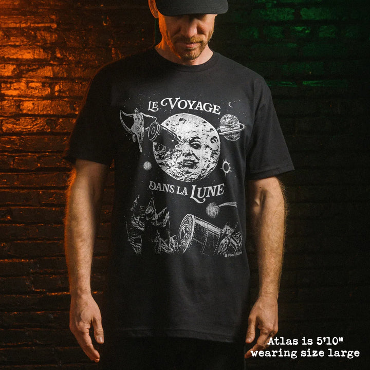 Male model wearing black premium tee with a trip to the moon graphic 