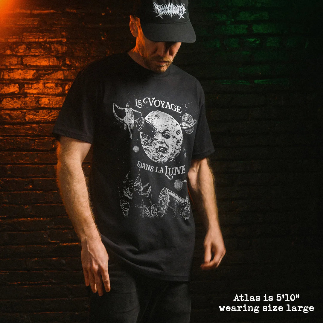 Male model wearing black premium tee with a trip to the moon graphic 
