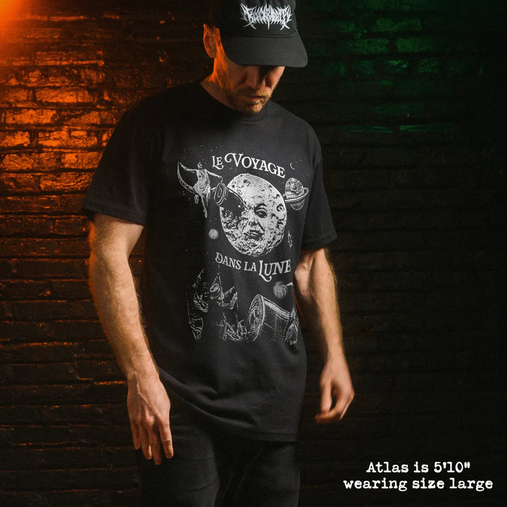 Male model wearing black premium tee with a trip to the moon graphic 