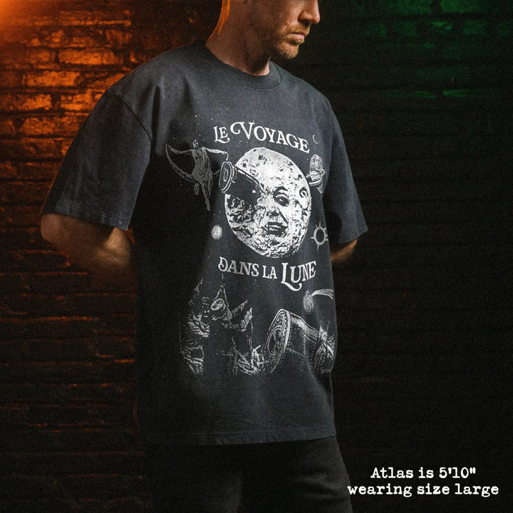 Male model wearing stone washed heavy tee with a trip to the moon graphic 