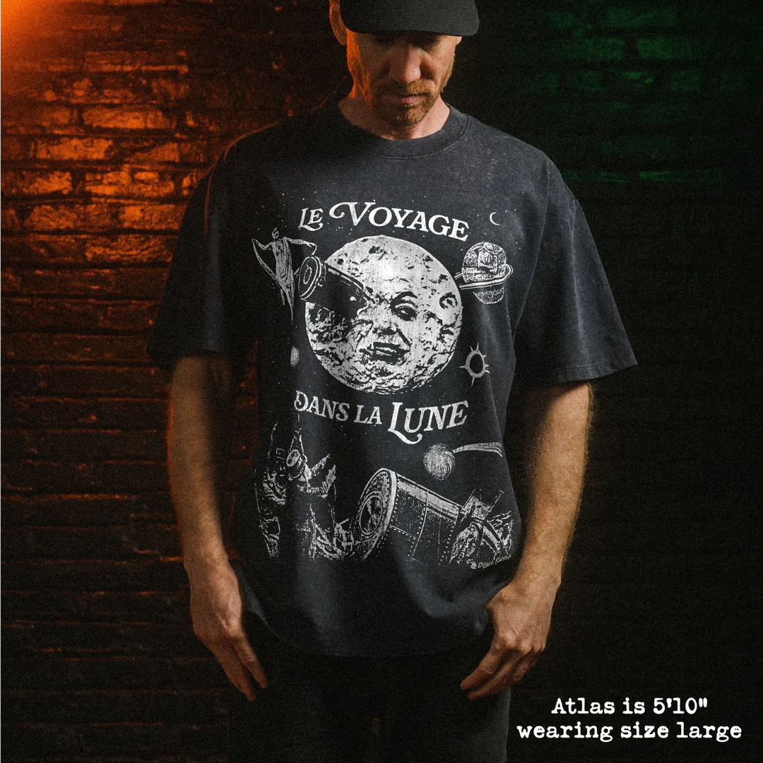 Male model wearing stone washed heavy tee with a trip to the moon graphic 
