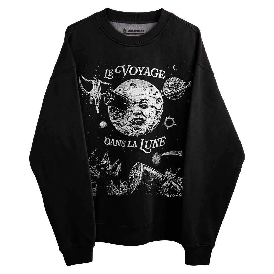 Black crewneck sweatshirt with ’le voyage dans la lune’ design featuring a moon, planets and space-themed elements.